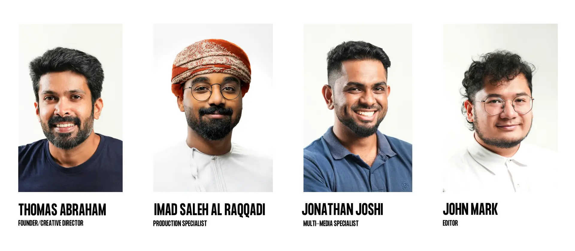 This image features a professional group portrait showcasing four smiling men, the core team members. From left to right, they are: Thomas Abraham, identified as the Founder / Creative Director; Imad Saleh Al Raqqadi, the Production Specialist; Jonathan Joshi, the Multi-Media Specialist; and John Mark, the Editor. Each individual is presented in a friendly headshot against a clean, light background, conveying an approachable and expert team.